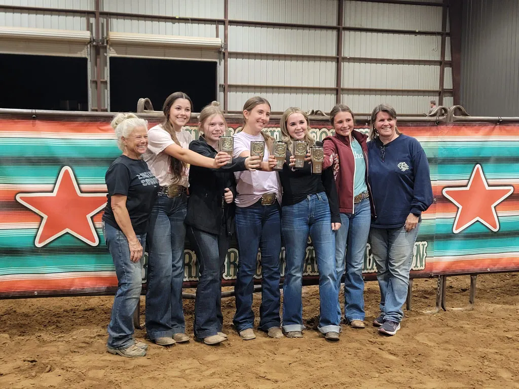 Rich at Heart team celebrating with trophies at barrel racing event
