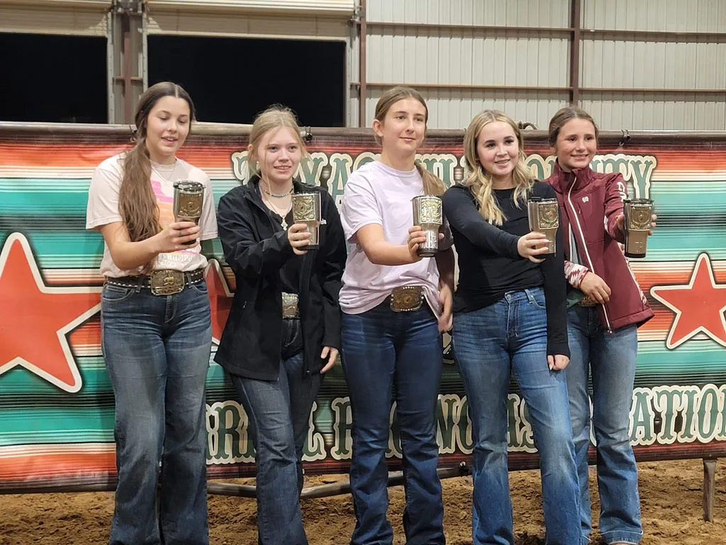 Youth riders showing off their trophies